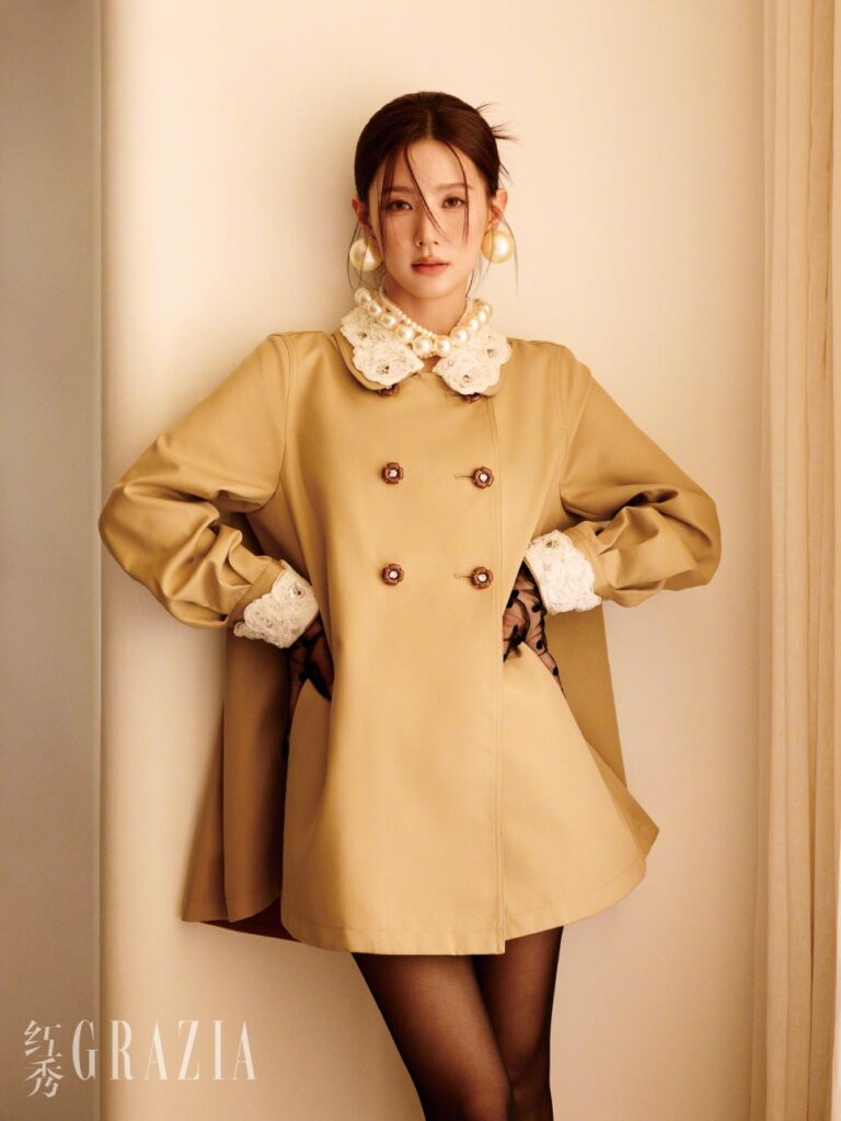 Miyeon standing confidently in beige mini trench with voluminous sleeves and pearl accessories for Grazia