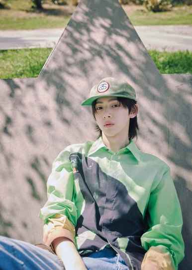 HYBE new boy group CORTIS member in a black beanie and casual jacket smiling softly outdoors.