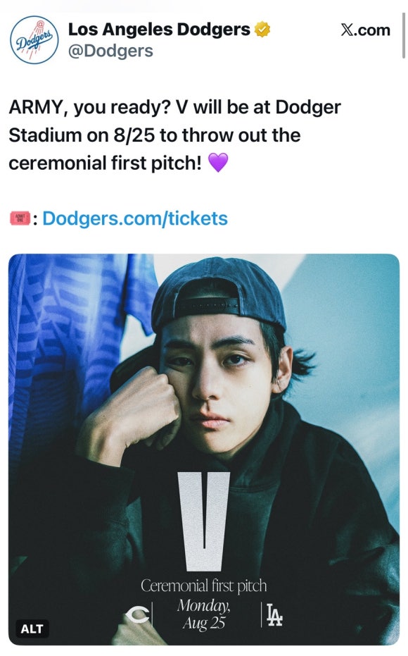 BTS's V in a Tigers jersey, smiling and making peace signs with both hands during a previous baseball appearance