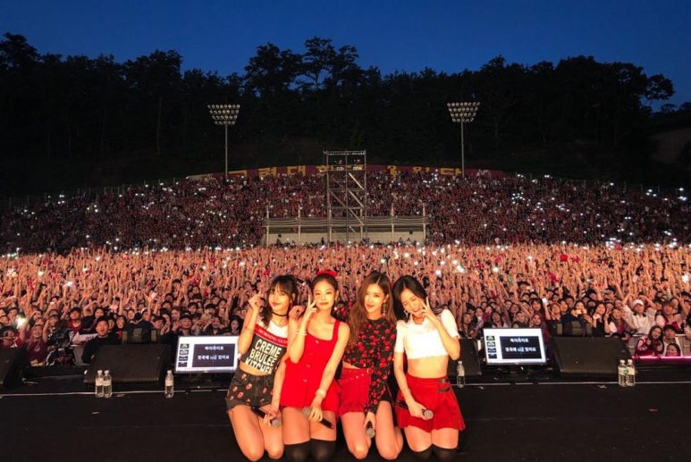 BLACKPINK posing confidently in casual concert gear, teasing fans for their YG comeback plans 2025.
