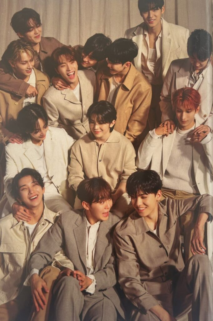 K-pop group Seventeen smiling warmly in beige and neutral outfits, symbolizing unity and friendship, highlighting Seventeen UNESCO donation and global youth empowerment.