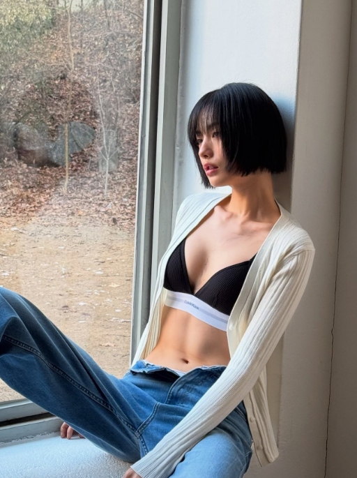 Sitting by the window in introspection, Nana exudes vulnerability and strength—a visual prelude to her "Nana Seventh Heaven 16" era.