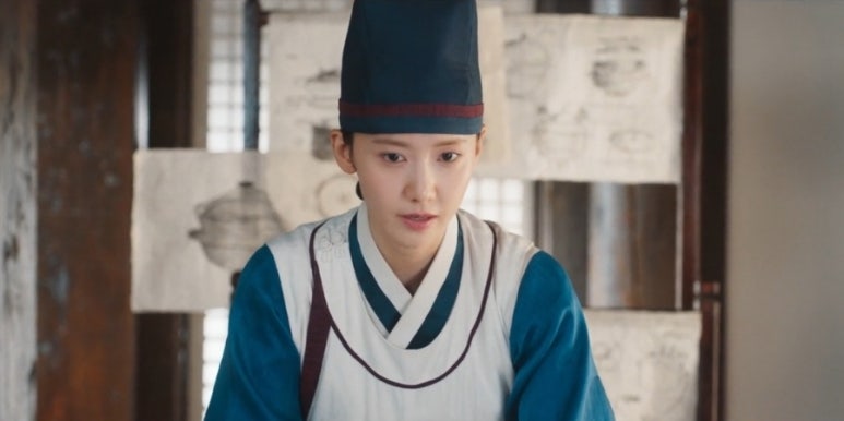 Focused Im YoonA in chef uniform working on food plans in Tyrant Chef kitchen