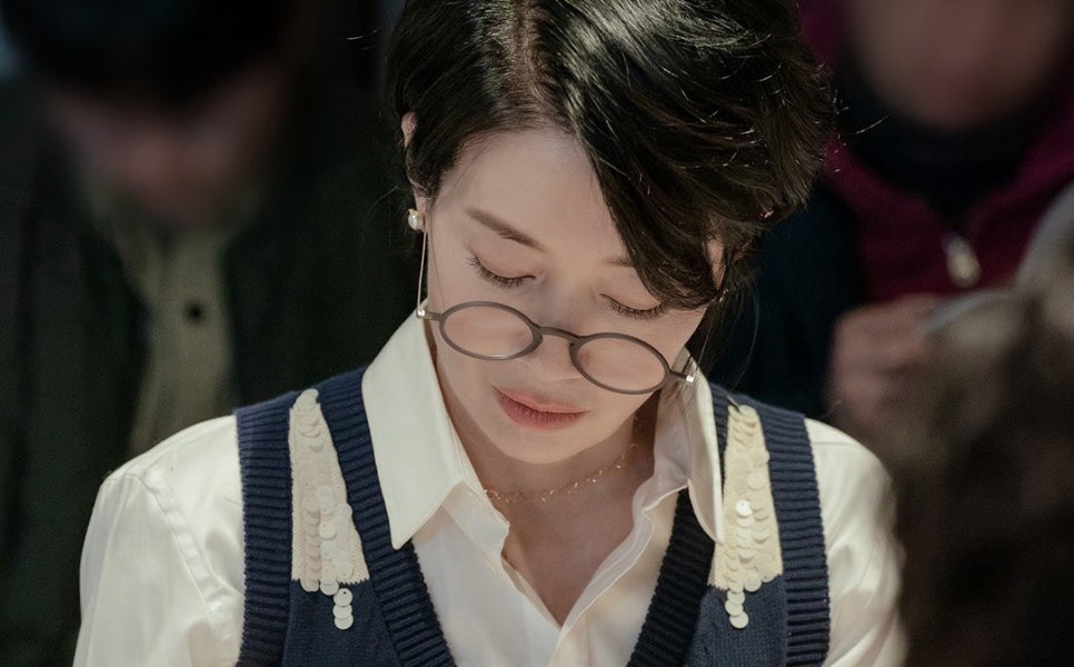 A serious-looking actress wearing glasses during the script reading of “Nice to Not Meet You.”