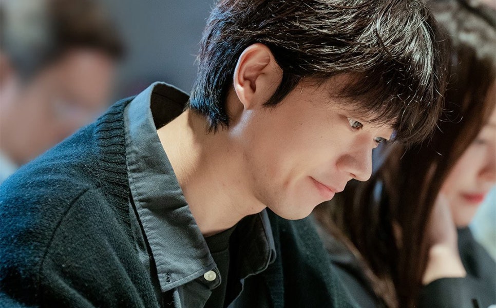 A smiling male actor reading the script for “Nice to Not Meet You.”