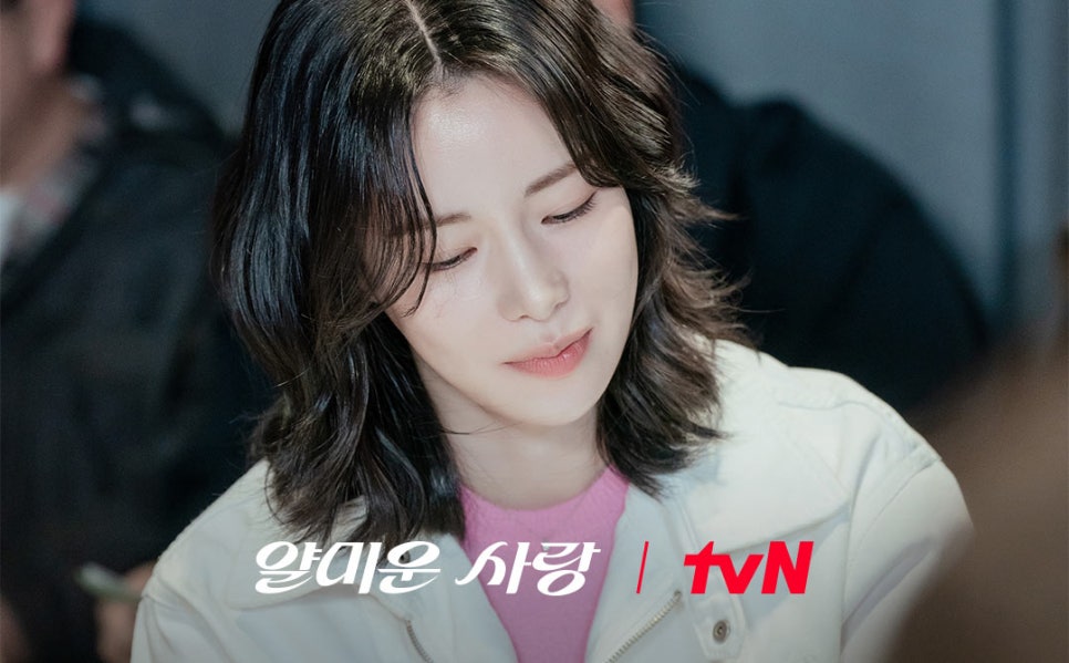 A short-haired actress smiling softly while reading her script for “Nice to Not Meet You.”