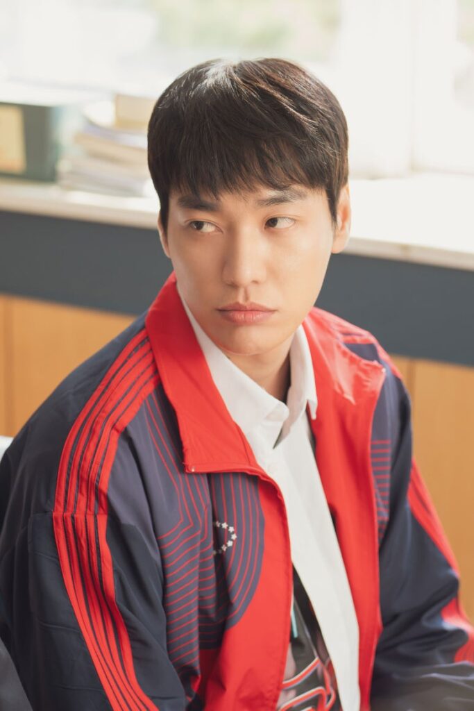 Kim Young Kwang as Do Jin showing a serious expression in a classroom in The First Ride