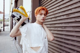 CORTIS debut album sales 2025 member with orange hair and sneakers photoshoot