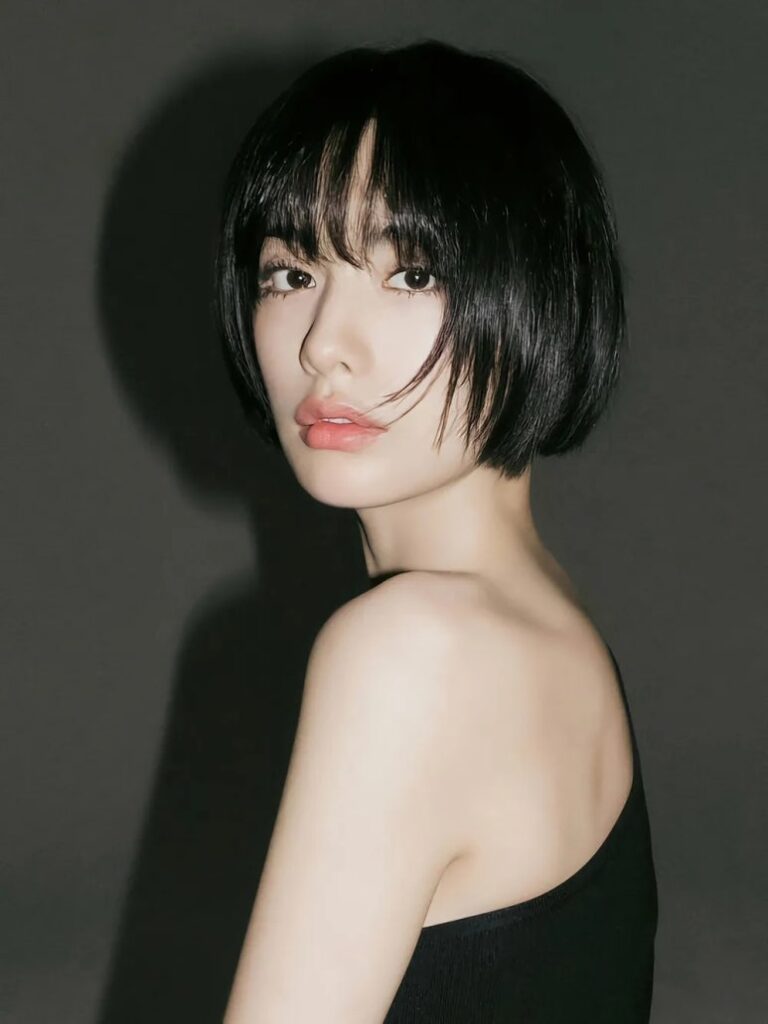 Close-up of Nana with short black hair and dramatic shadows, showcasing her bold new persona for the "Nana Seventh Heaven 16" solo album.