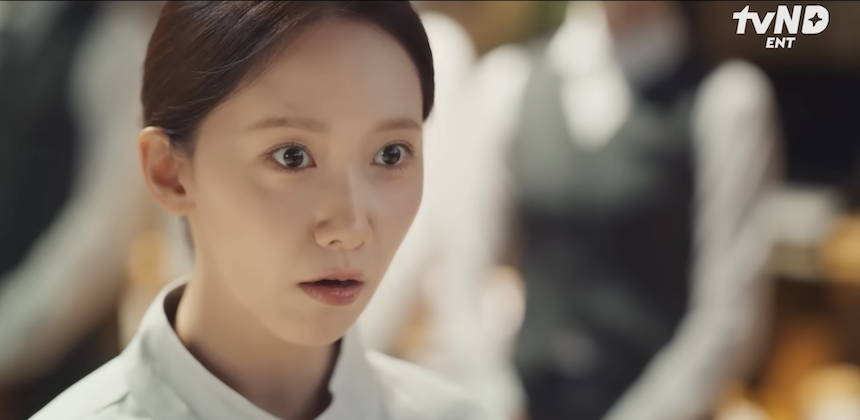 A close-up split screen image featuring two Korean actors (Im Yoon-ah and Lee Chae-min) from the drama 'Bon Appétit, Your Majesty' looking at each other or slightly off-camera with soft, pleasant expressions.