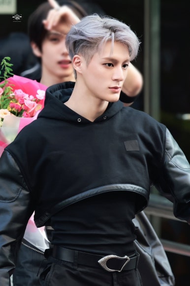 NCT DREAM Beat It Up teaser behind-the-scenes shot of member in black cropped hoodie with silver hair