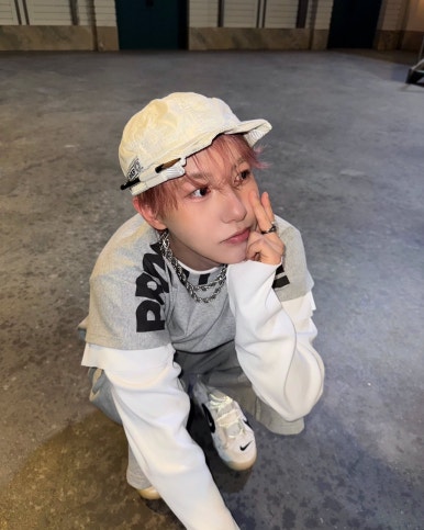 NCT DREAM Beat It Up teaser cool squatting pose of member in street-style outfit with bucket hat