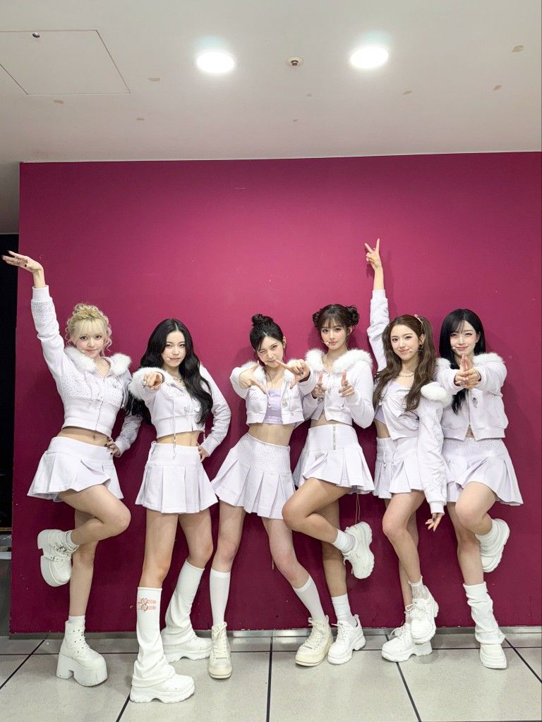 Nmixx striking playful poses in white winter stage outfits from Blue Valentine era