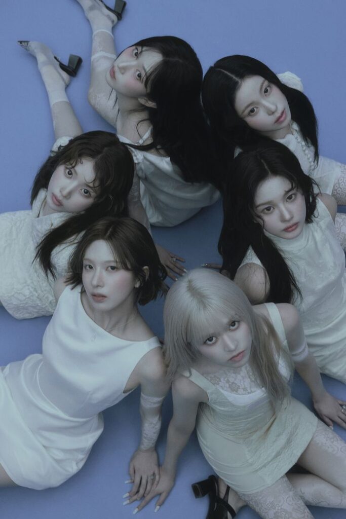 Nmixx Blue Valentine concept photo with members in elegant white dresses and soft lighting