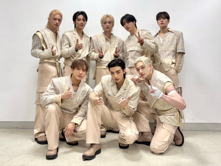 Stray Kids group in matching sparkling beige outfits backstage after powerful performance at 2025 Korea Grand Music Awards.