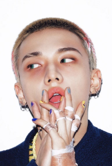 Stray Kids DO IT teaser showing buzzcut member with vibrant nail art and fierce makeup