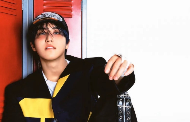 Stray Kids member leaning against red locker for ‘DO IT’ comeback concept photo