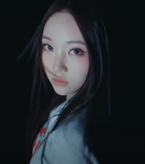 ALLDAY PROJECT member in dark lighting with hair blowing and intense gaze — comeback visual teaser