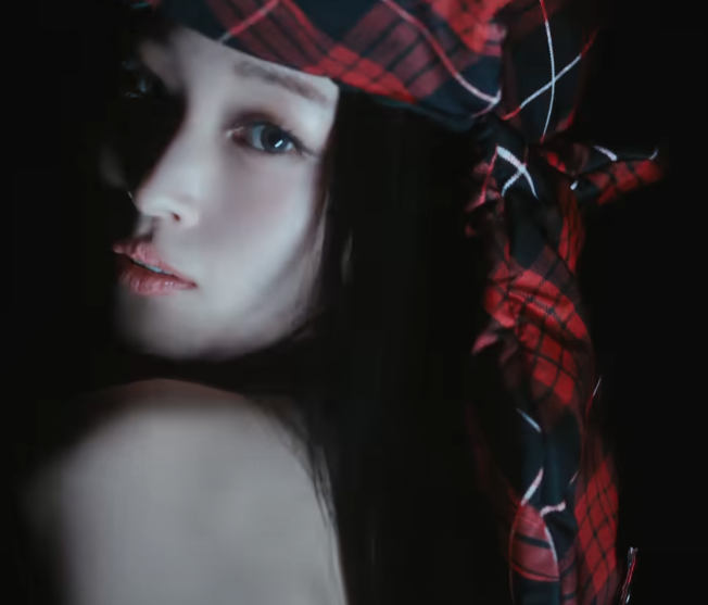 ALLDAY PROJECT member in dramatic red plaid headwrap and bare shoulder look — ALLDAY PROJECT comeback concept teaser