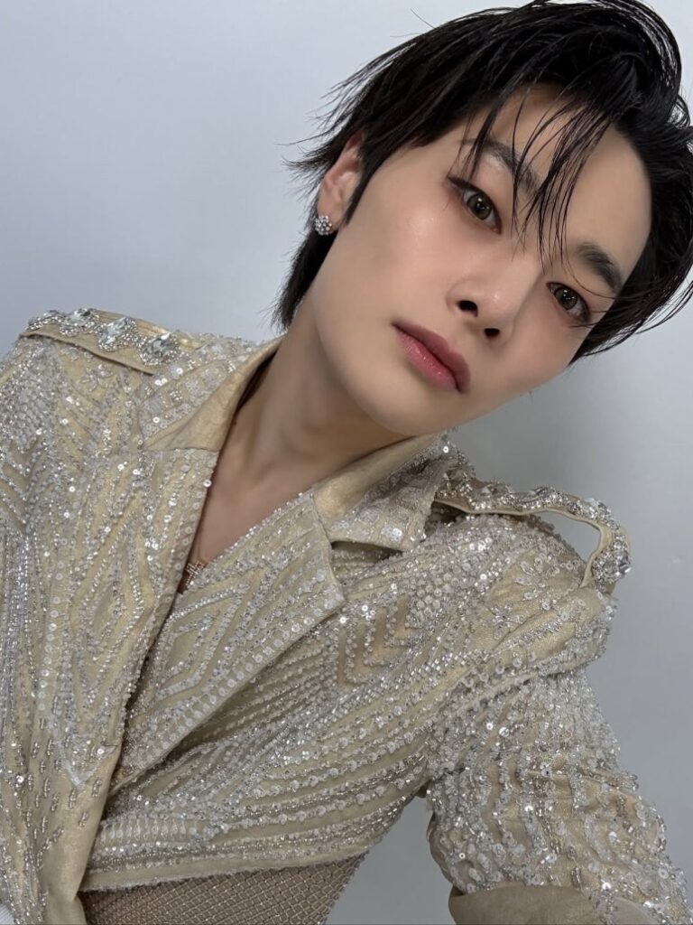 Close-up selfie of Hyunjin from Stray Kids in sequin-embellished stage costume during 2025 KGMA performance.