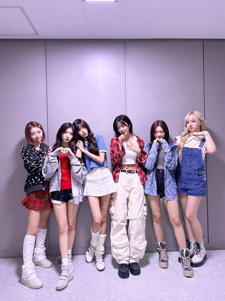 Nmixx backstage in colorful outfits after Blue Valentine Inkigayo win