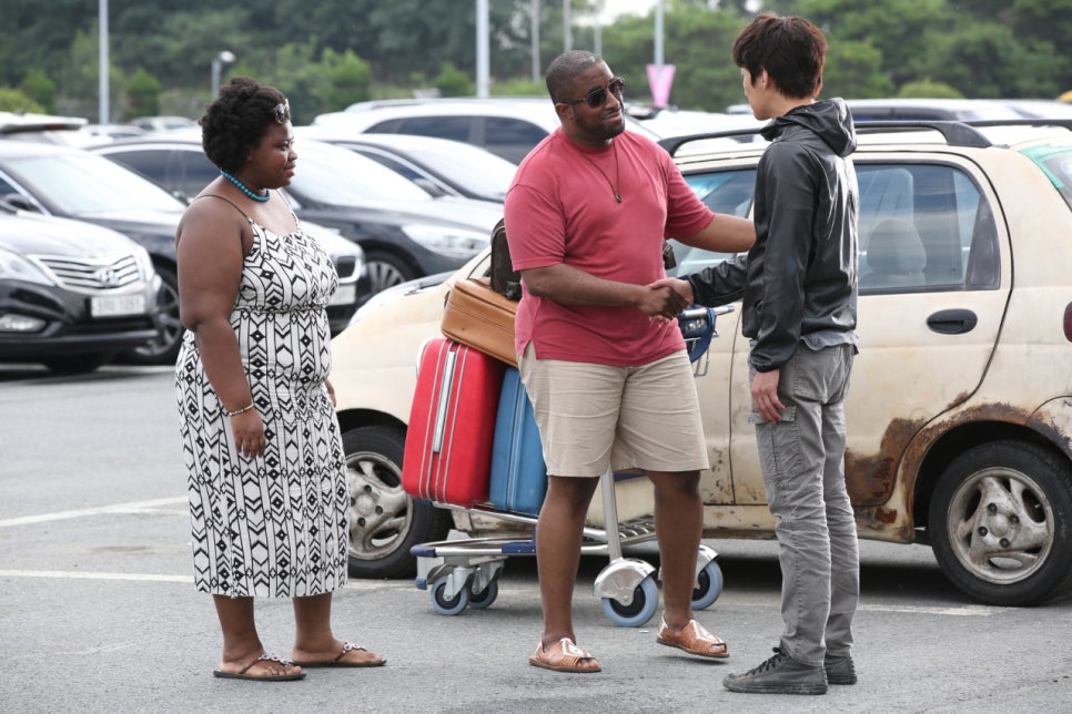 Foreign couple meeting the protagonist in a parking lot in Fabricated City film