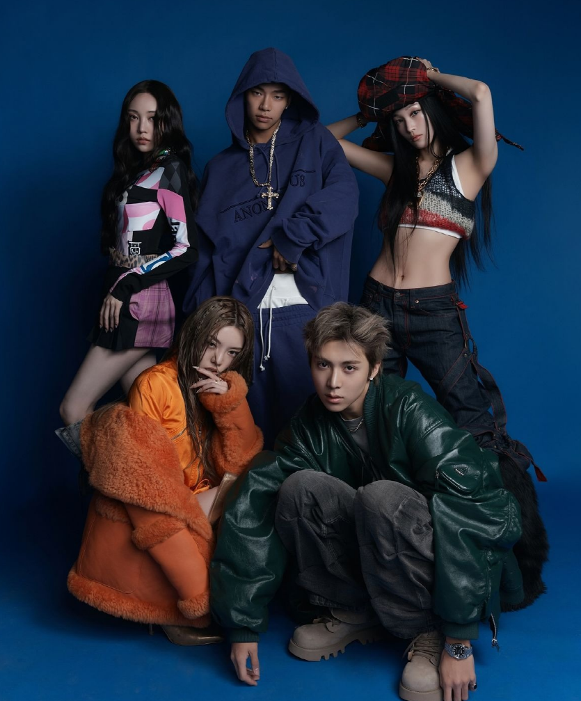 ALLDAY PROJECT in bold streetwear against blue backdrop — official ALLDAY PROJECT comeback promo shoot