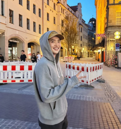 Lee Jong Suk in gray hoodie walking through city streets — relaxed moment after fanmeeting cancellation in Manila