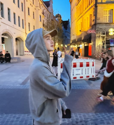 Lee Jong Suk looking up at evening sky in a hoodie — reflective scene after sudden fanmeeting cancellation news