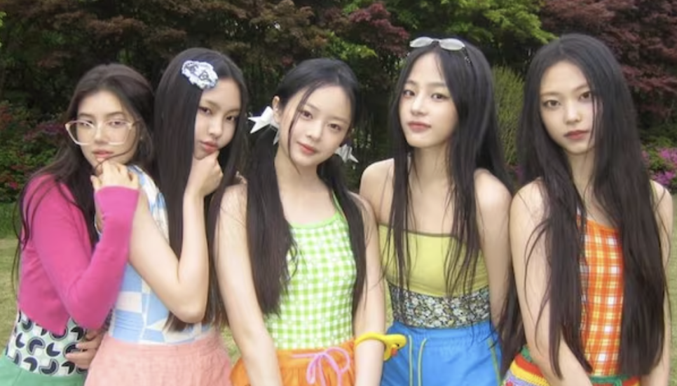 NewJeans return to ADOR – Group posing in vibrant summer outfits showing unity and fresh energy after rejoining ADOR