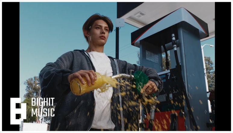 CORTIS member pours orange soda at a gas station — a symbolic visual from their K-pop debut MV.