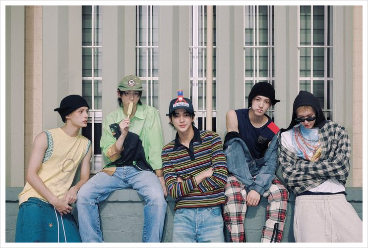 CORTIS casually poses against a building, capturing the youth-driven energy of their K-pop debut campaign.